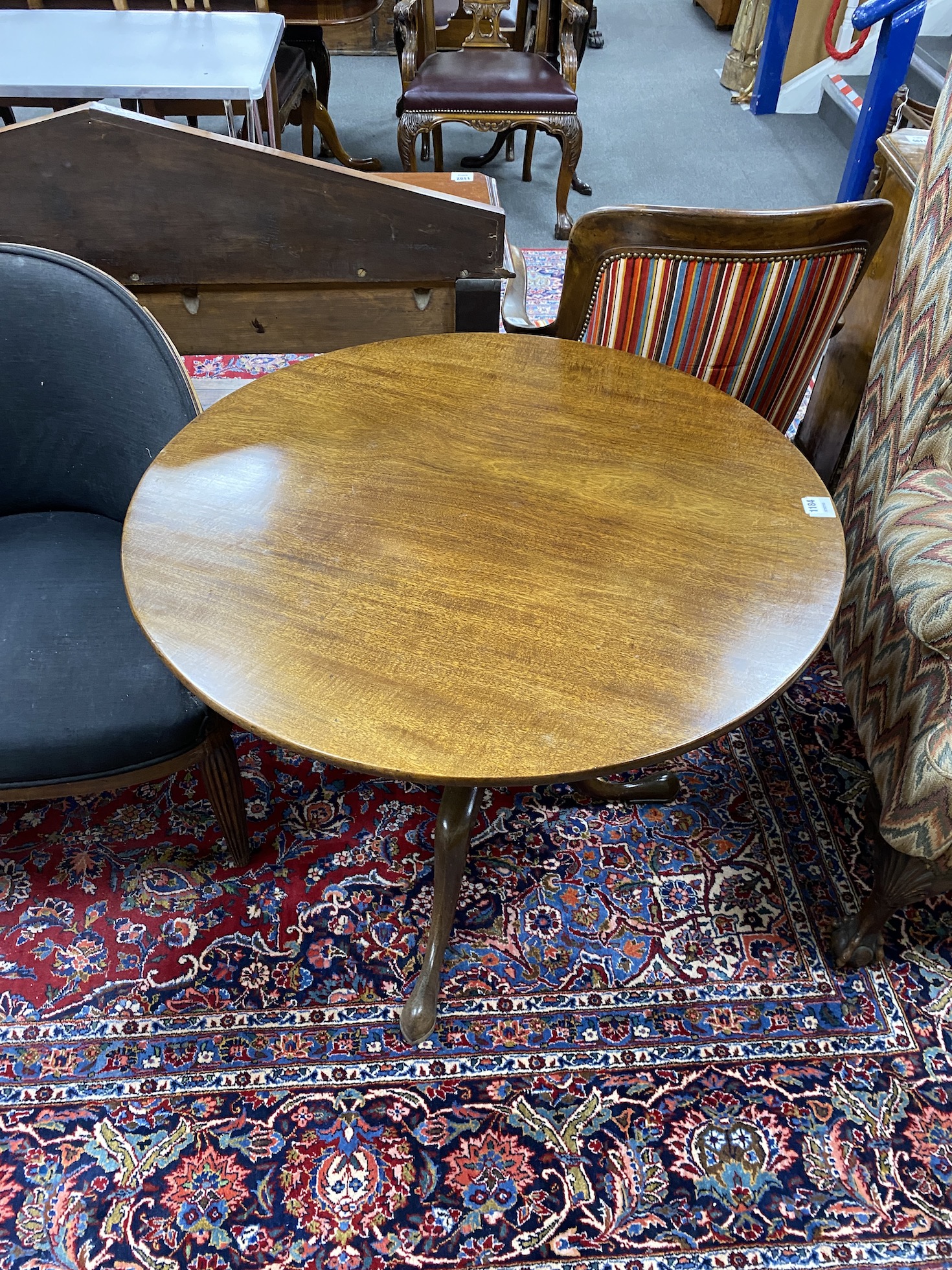 A George III mahogany circular tilt top tripod tea table, diameter 89cm, height 74cm